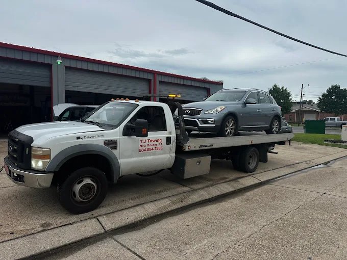 TJ Towing tow truck loading a vehicle in New Orleans